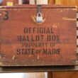 A wooden ballot box.