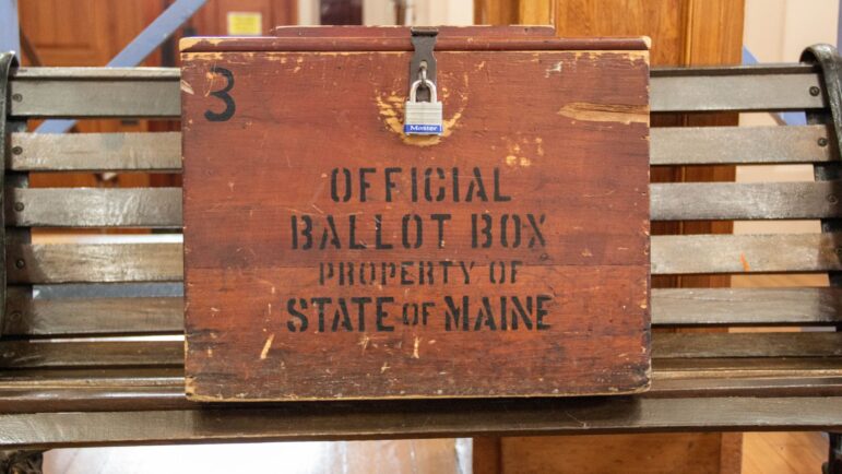 A wooden ballot box.