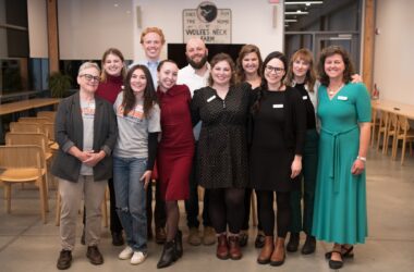 members of the newsroom pose for a group photo.