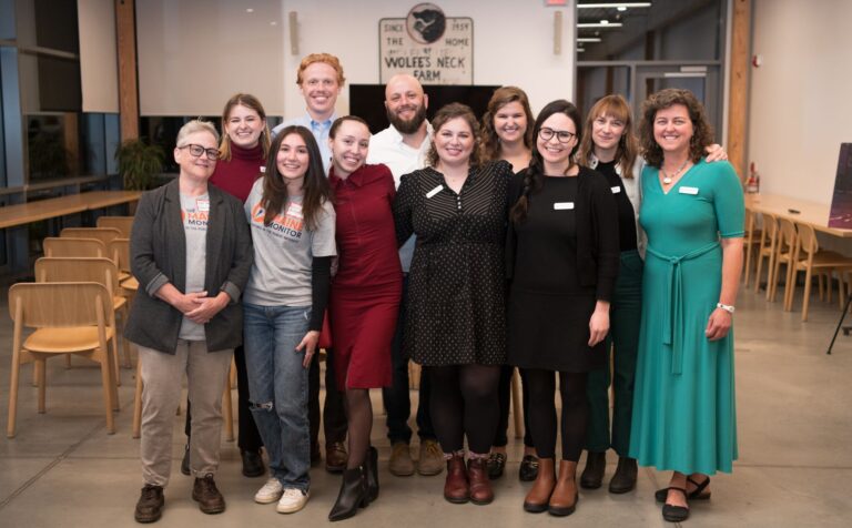 members of the newsroom pose for a group photo.