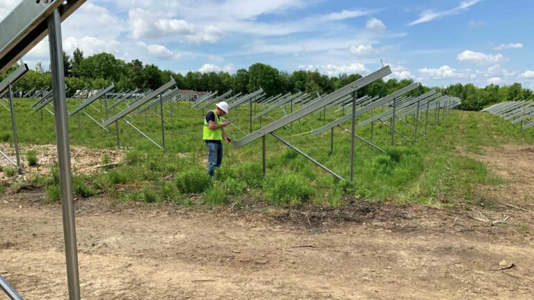 Worker inspects the construction of a community solar farm