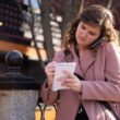 Maine Monitor reporter Rose Lundy jots down notes while on a phone call.