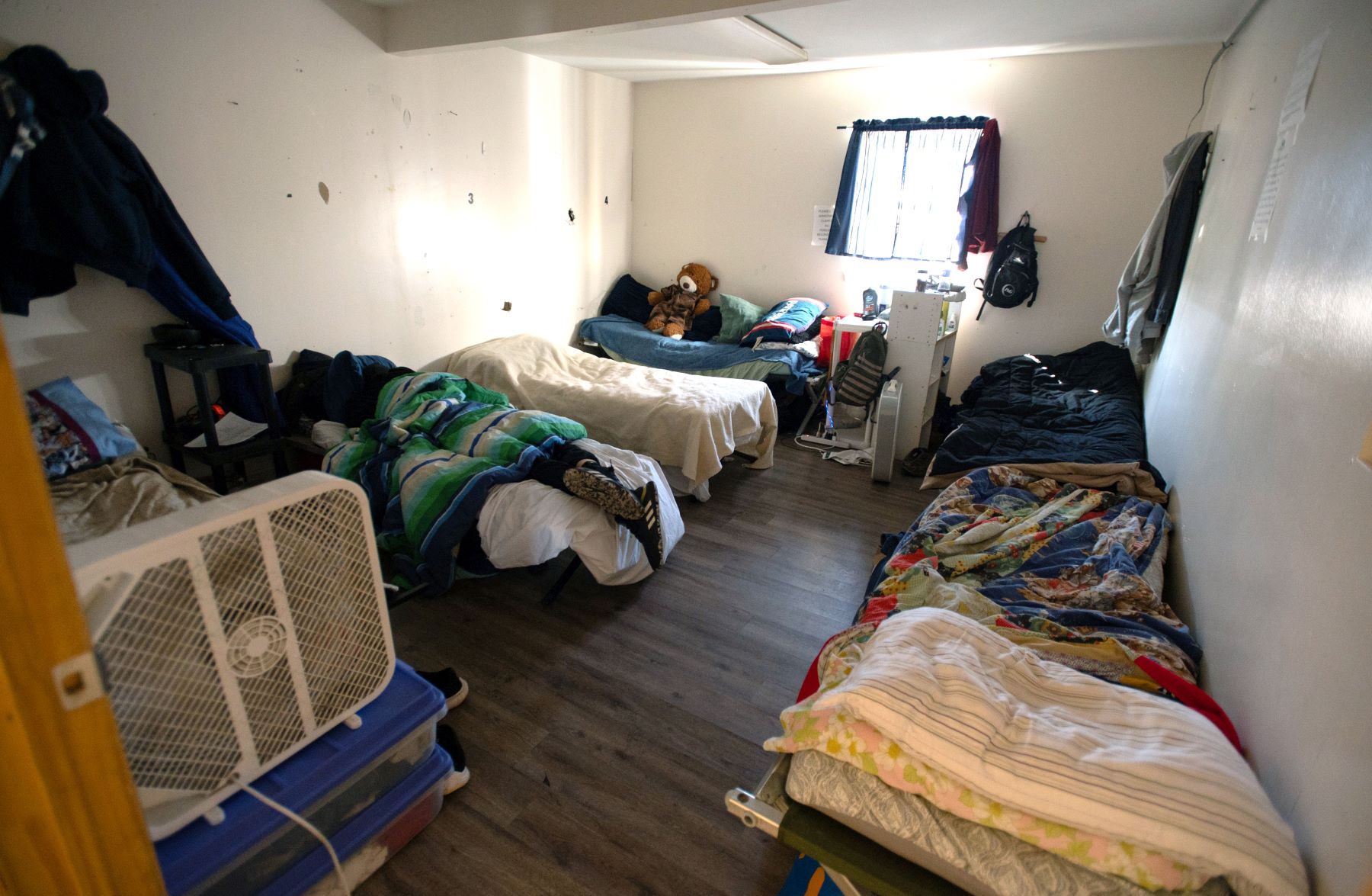 a room with beds inside a shelter.