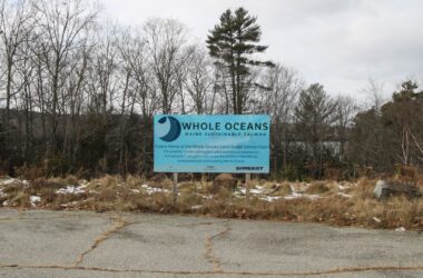 a sign touting the future home of the Whole Ocean salmon farm.