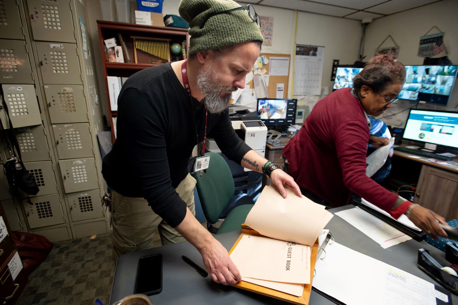 people shifting through files and paperwork at a shelter.