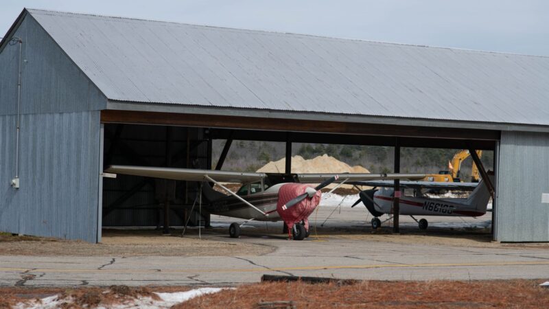 planes in a hangar at the fryeburg airport.