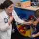 a pediatric student uses a stethoscope on a young child.