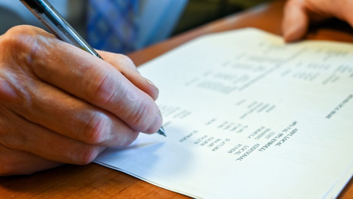 a person reviews information related to a school proposal.