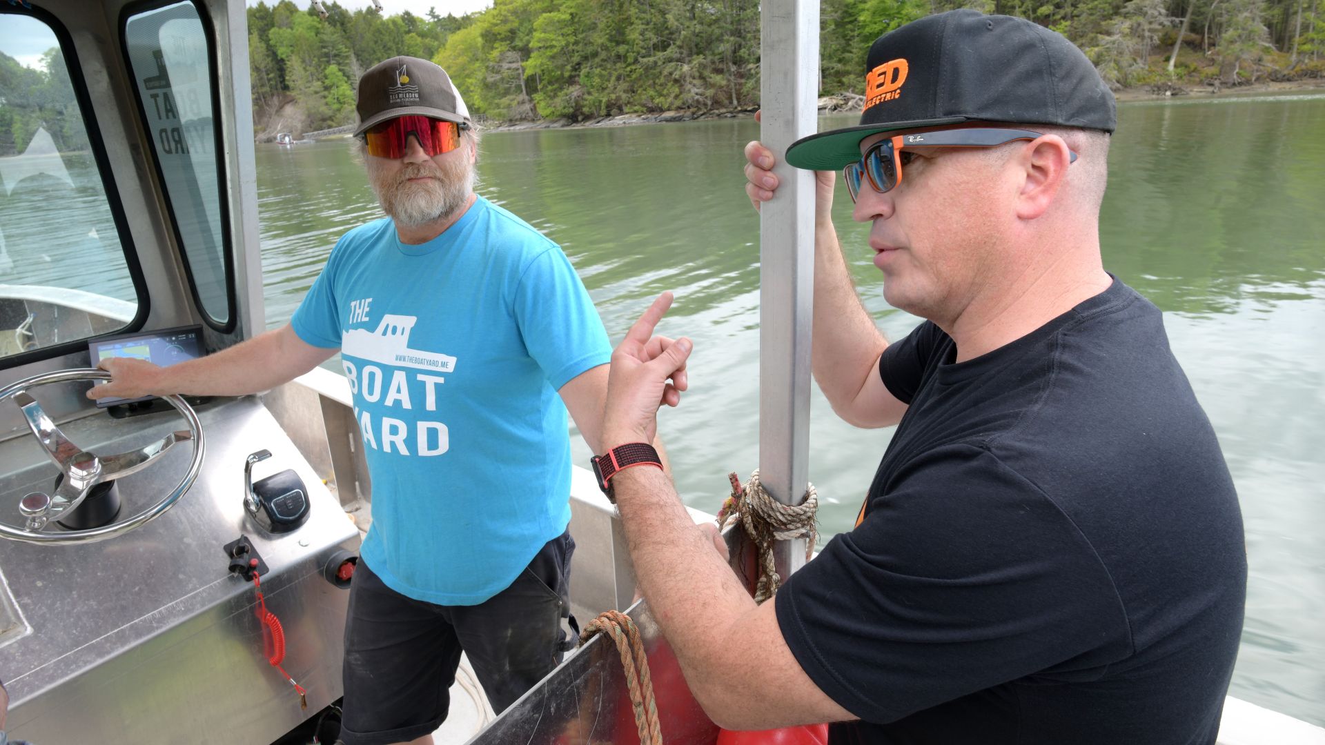 two men talking on a boat.