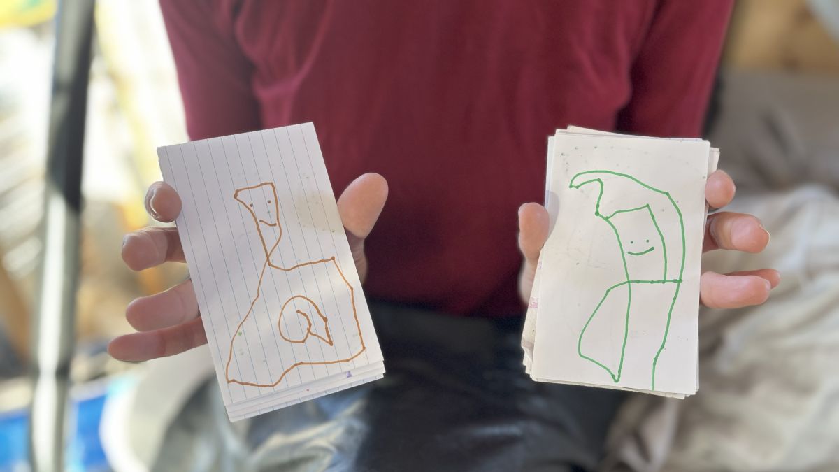 drawings being held up.