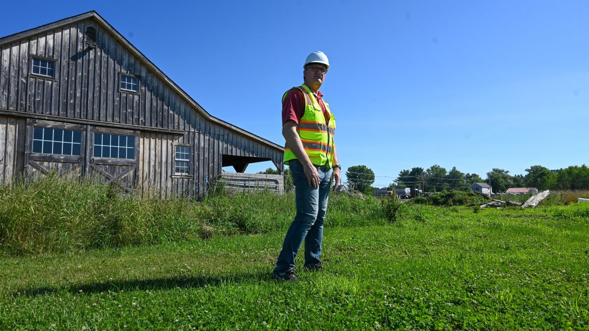 Chris Howell stands in front of a former horse barn.