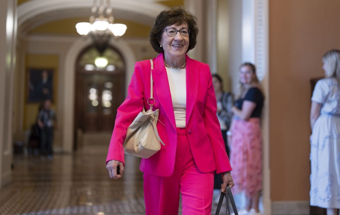Susan Collins walks through a hallway.
