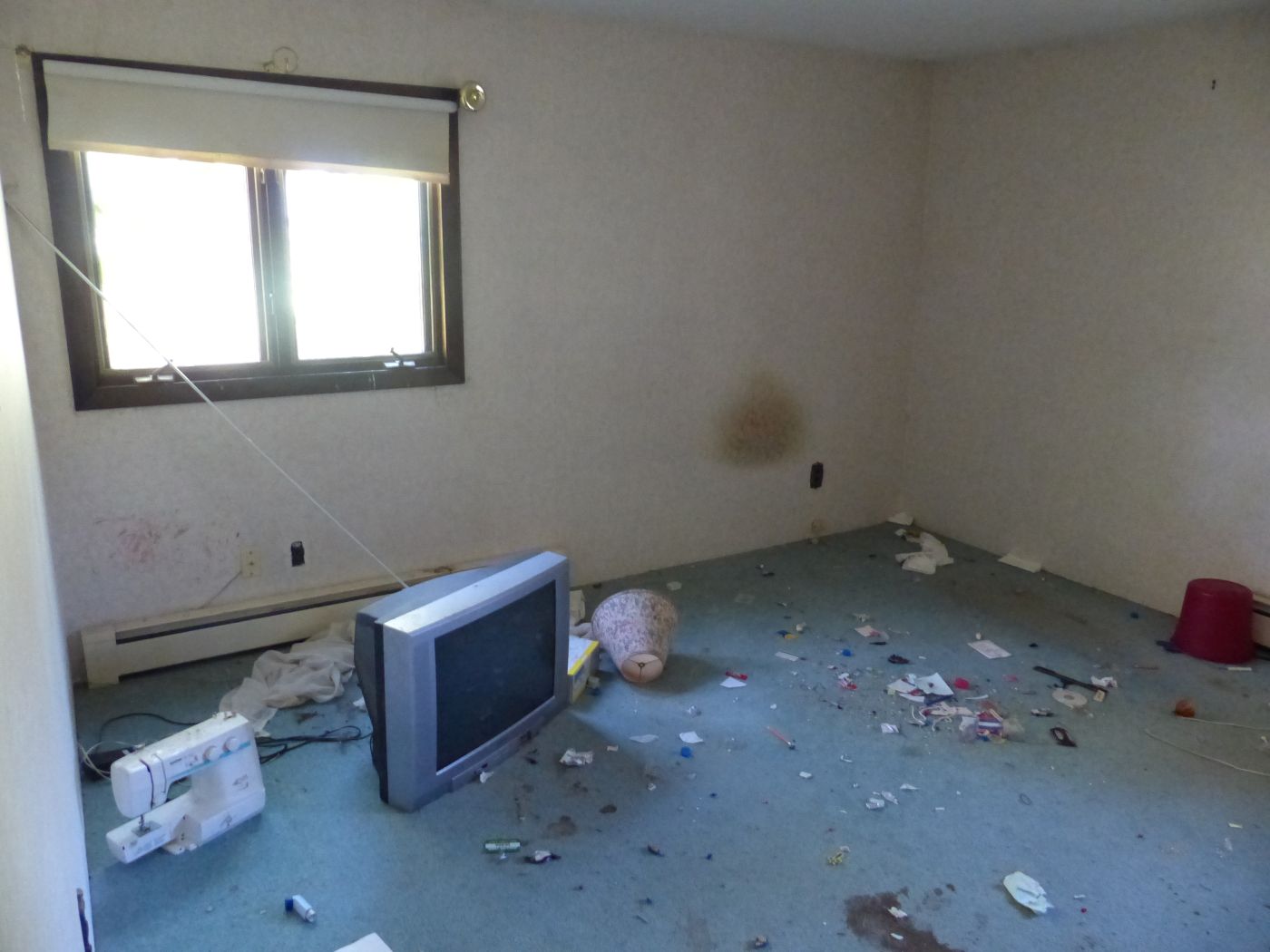garbage and broken equipment strewn across a room.
