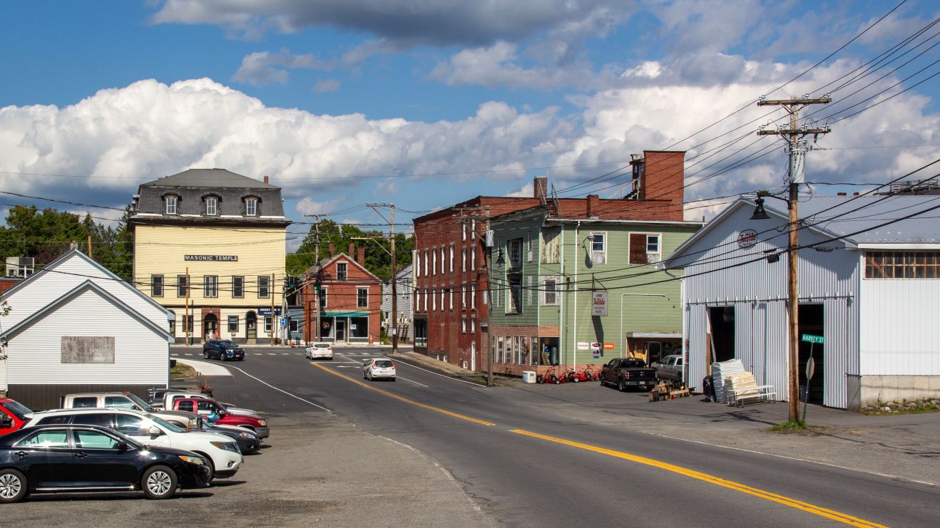 buildings line both sides of a road in Dover-Foxcroft.