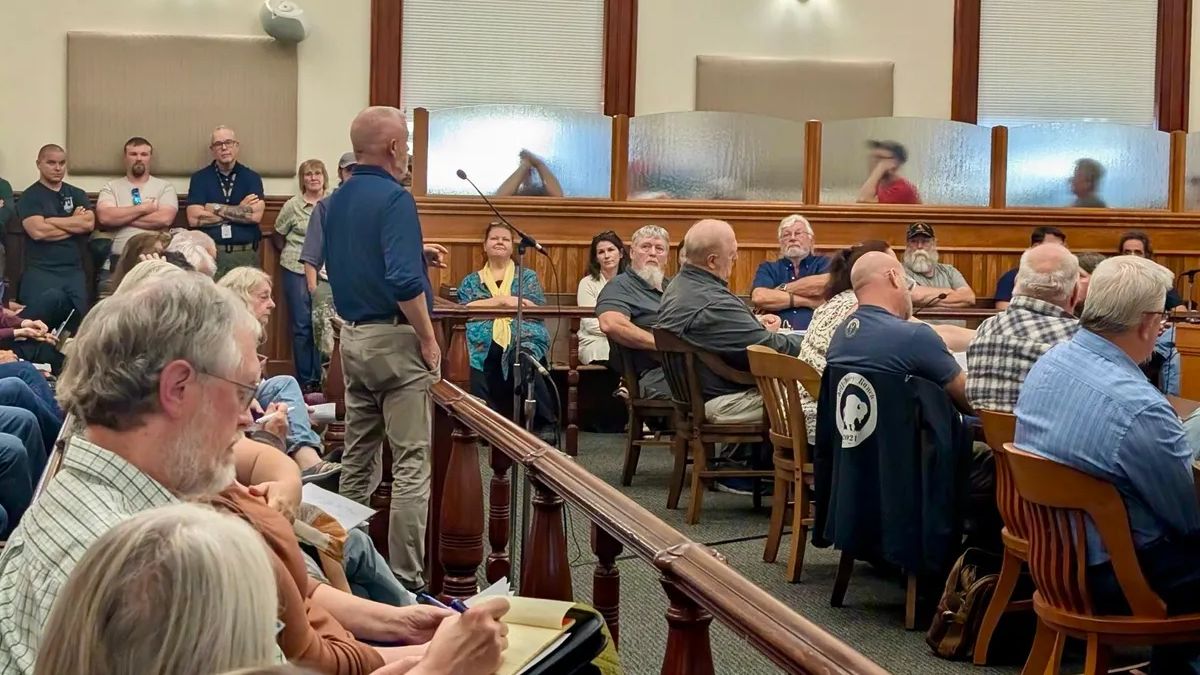 People listen to a speaker during the Washington County budget meeting.