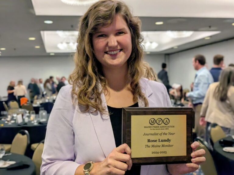 Rose Lundy holds her journalist of the year plaque.