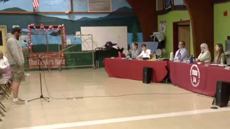 Adam Zajac speaking to school board members.