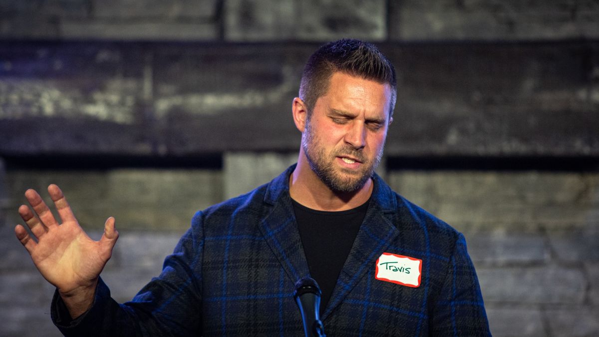 Pastor Travis Carey speaks during a prayer.