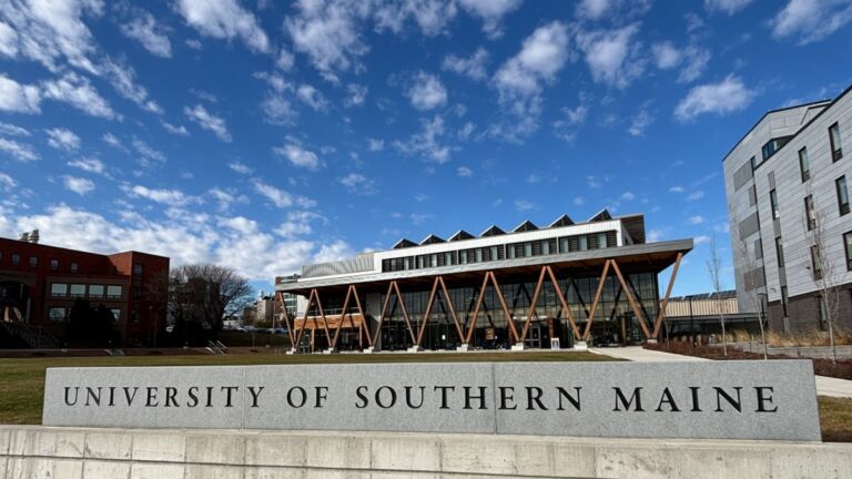 A University of Southern Maine sign in front of a building.