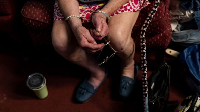 a person sitting in a chair waiting to be assisted.