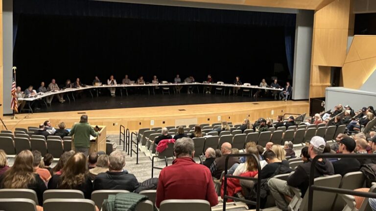 school board members listening to public comments.
