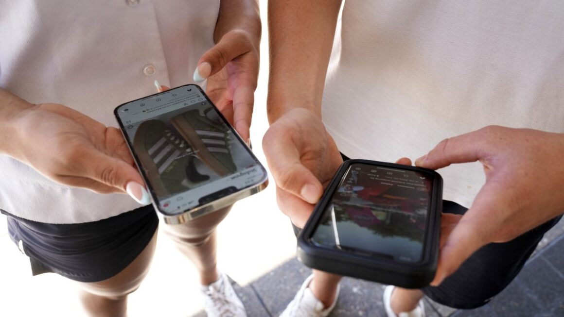 students holding their cellphones.