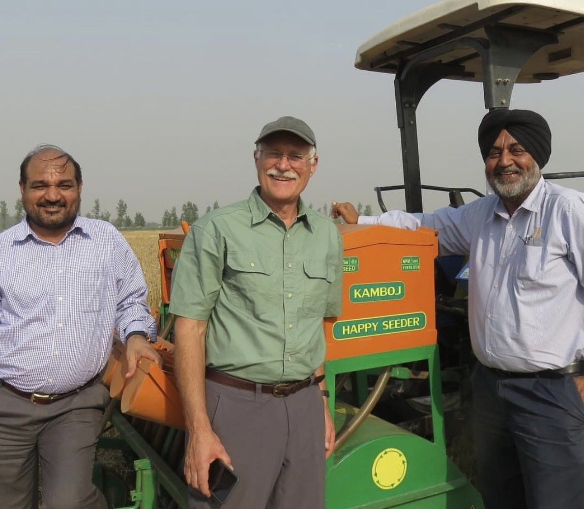 Bill Ginn with a seeder and two other men.