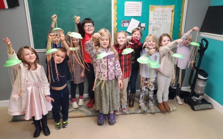 students showing off their crafts.