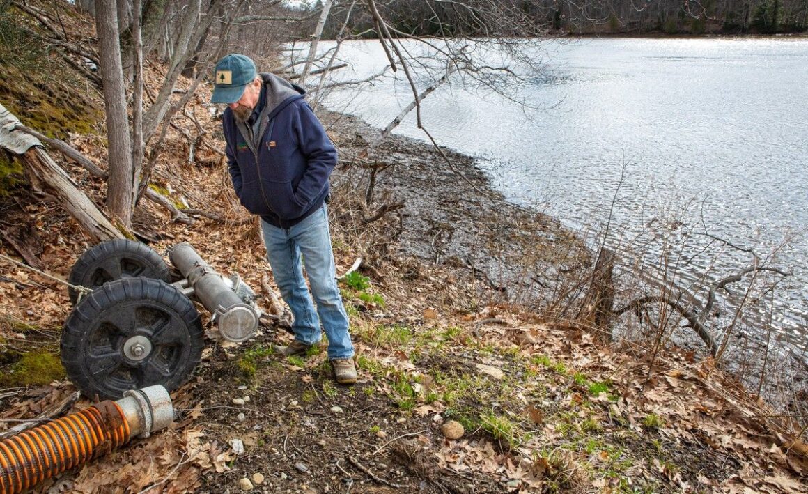 Rob Johanson stands next to an intake hose.