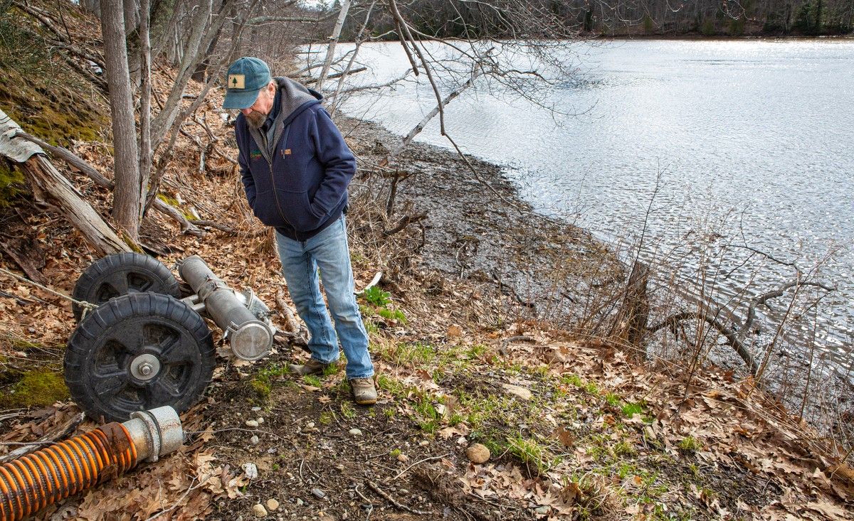 Rob Johanson stands next to an intake hose.
