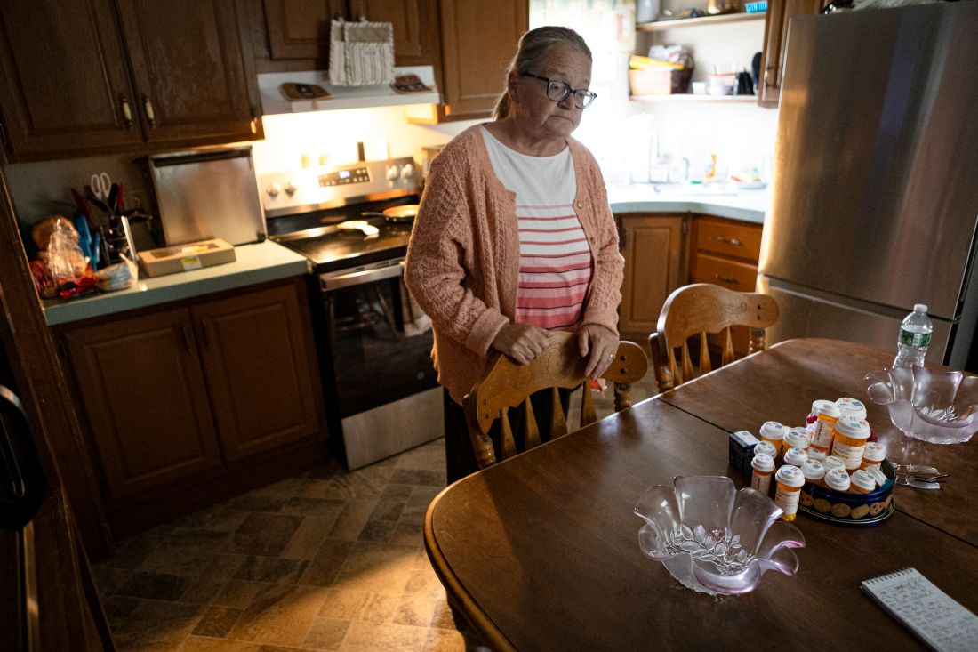 Christine Callahan standing in her kitchen.