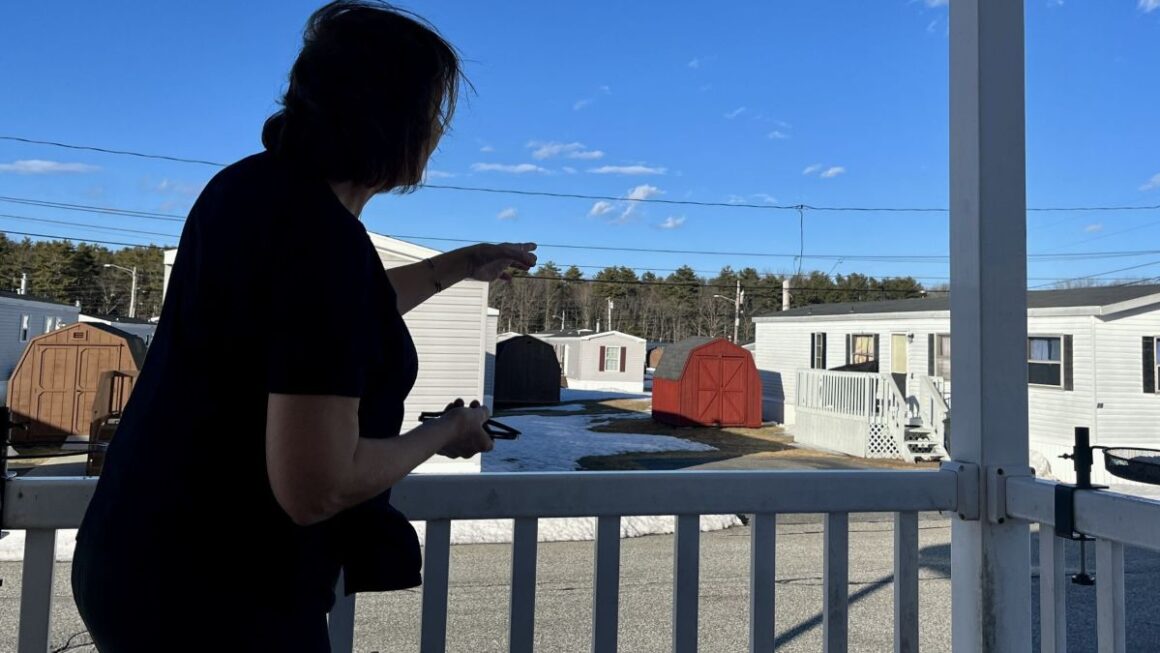 woman standing on her porch in a mobile home park.