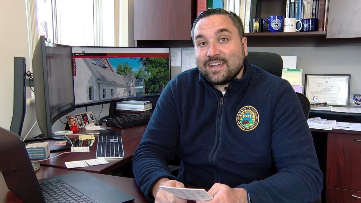 Michael Foley sits at his desk