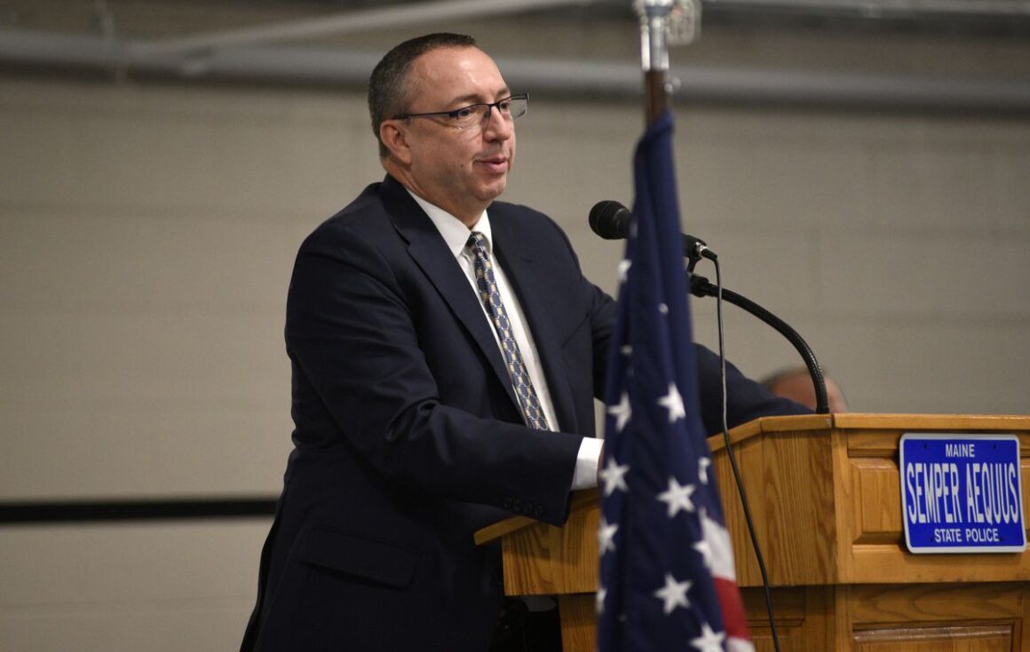 Michael Sauschuck speaks while standing at a podium.