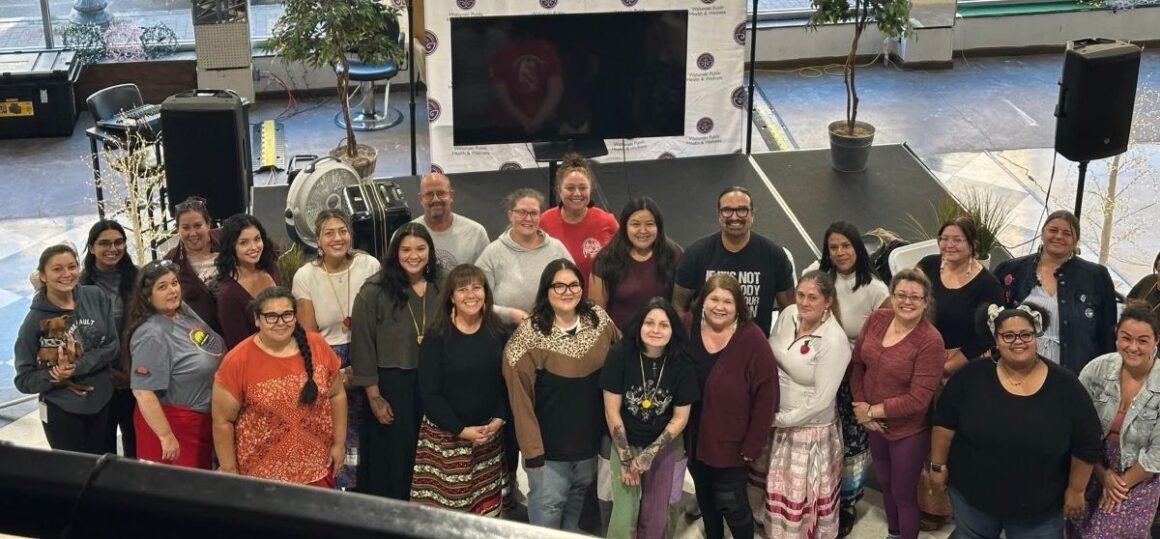 a large group of doulas pose for a photo.