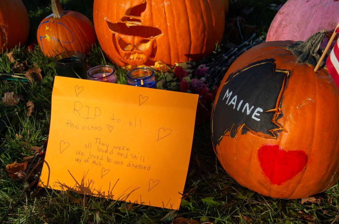 pumpkins and a note at a memorial site.