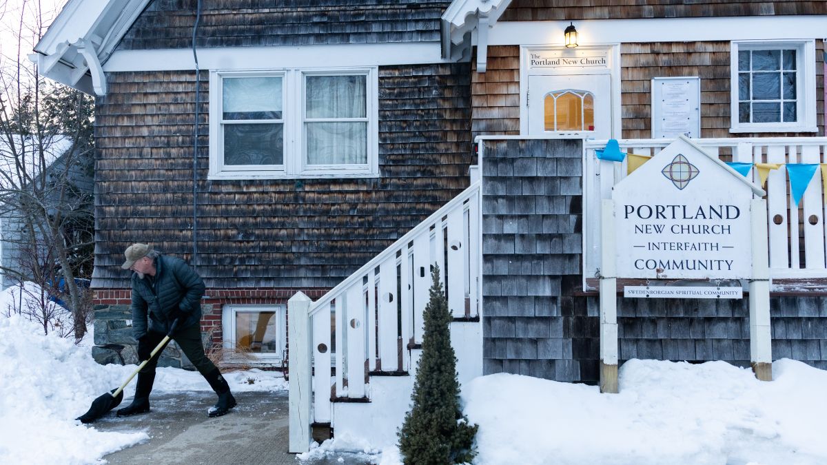 Paul Ridlon shovels snow in front of Portland New Church.