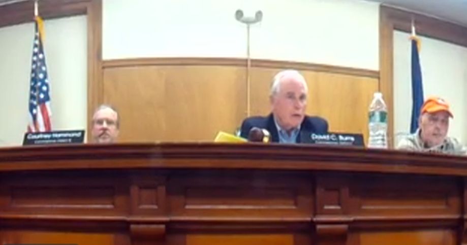 Commissioners Courtney Hammond, David Burns and Billy Howard sit during a meeting.