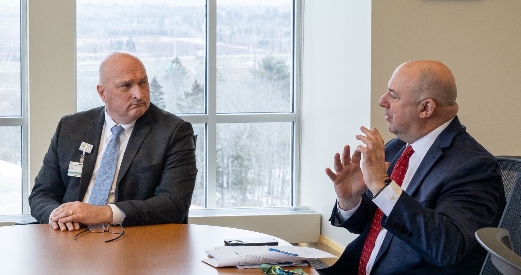 Paul Bolin and  James Rohrbaugh during a conversation at a conference table.