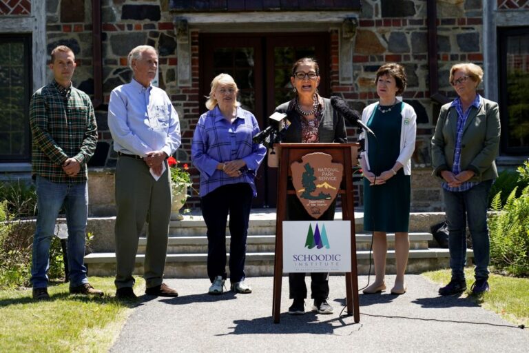 photo from a press conference that includes Deb Haaland, Jared Golden, Angus King, Janet Mills, Angus King, Janet Mills, Susan Collins and Chellie Pingree.