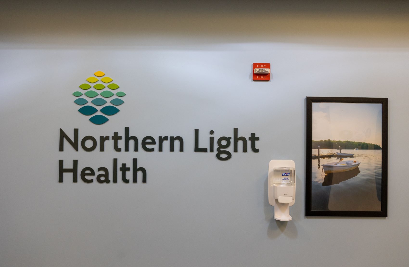 a sign for Northern Light Health on a wall inside one of its health care facilities. 
