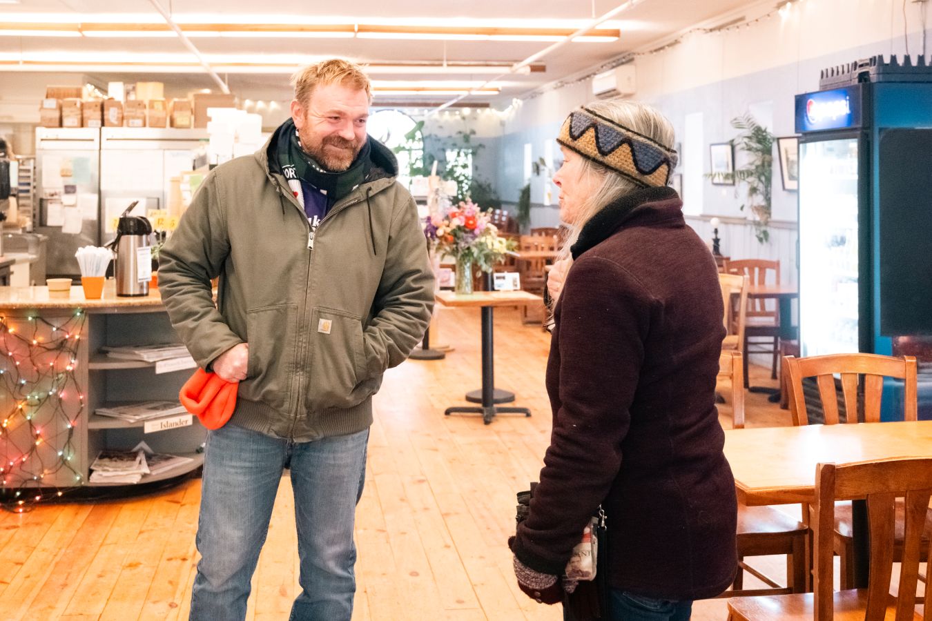 Graham Platner speaks with a woman.