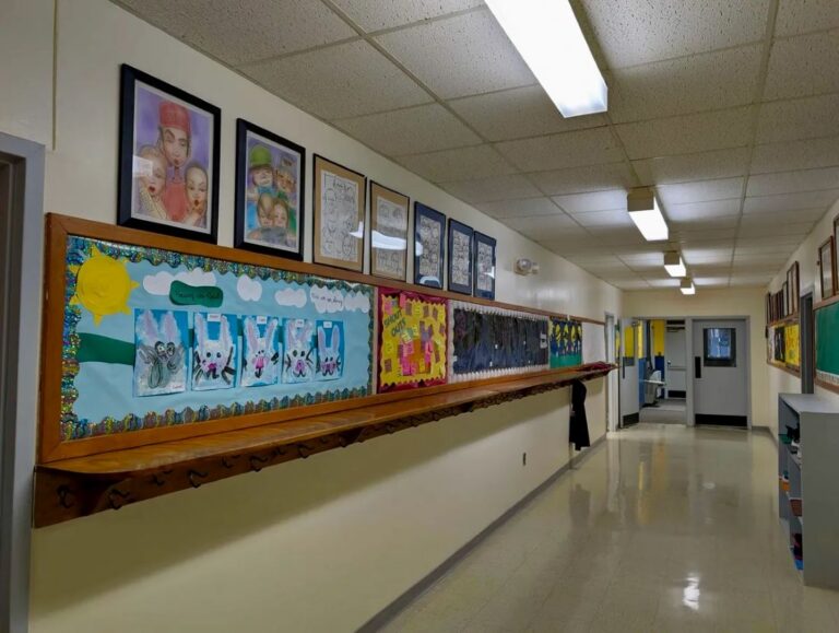 decorations cover the wall of a school hallway