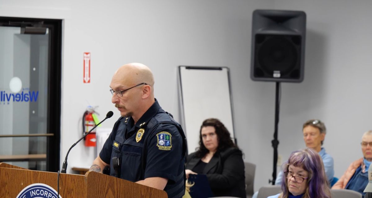 William Bonney speaks while standing at a podium.