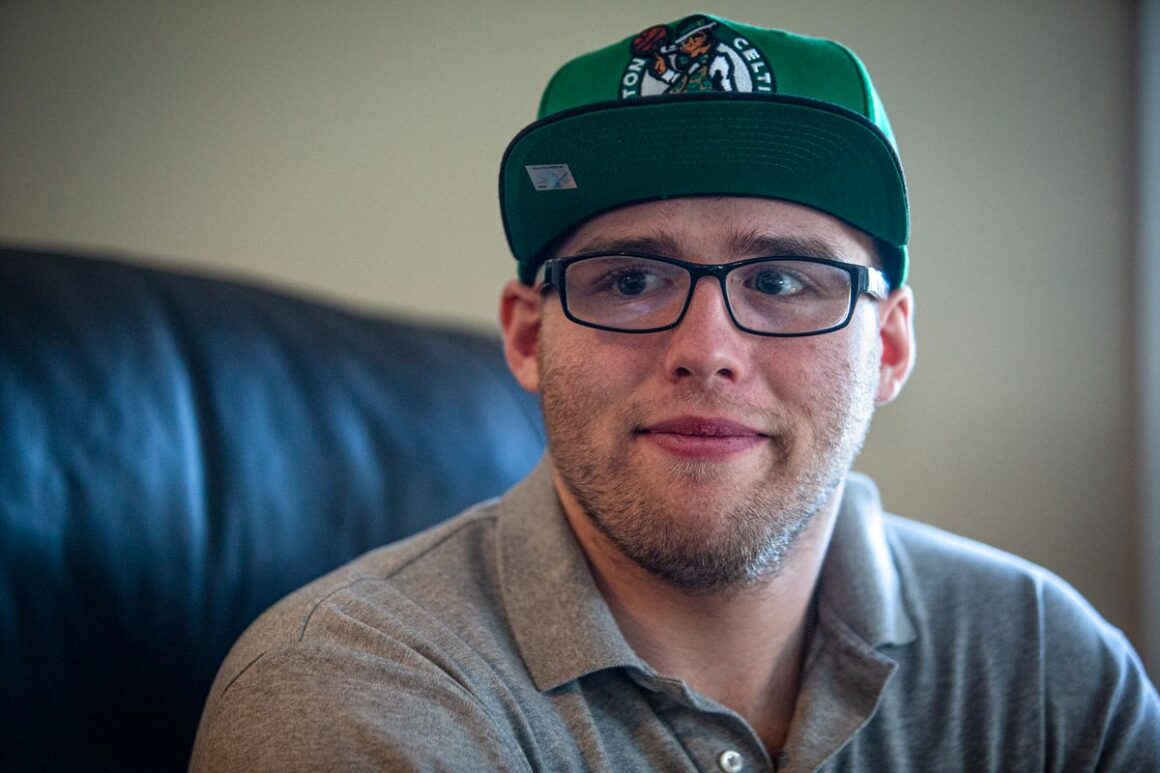 Zachary Swain sitting on a couch.