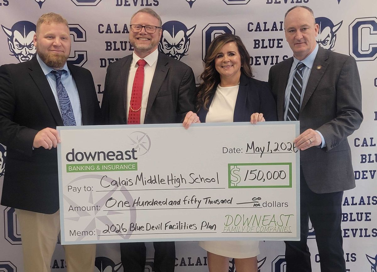 a group of four people hold up a large check for $150,000