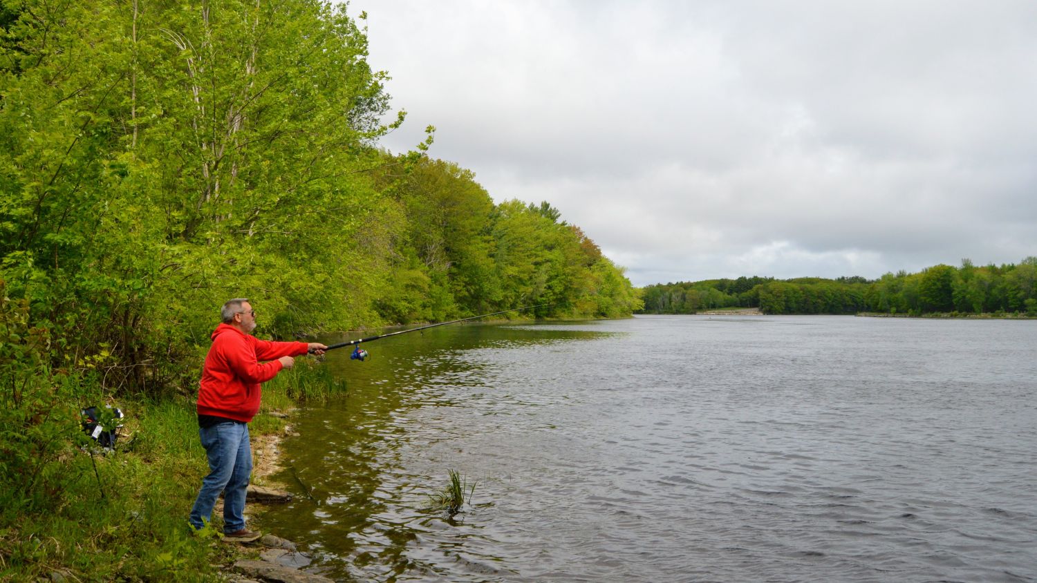 A man fishing in the Penobscot River.