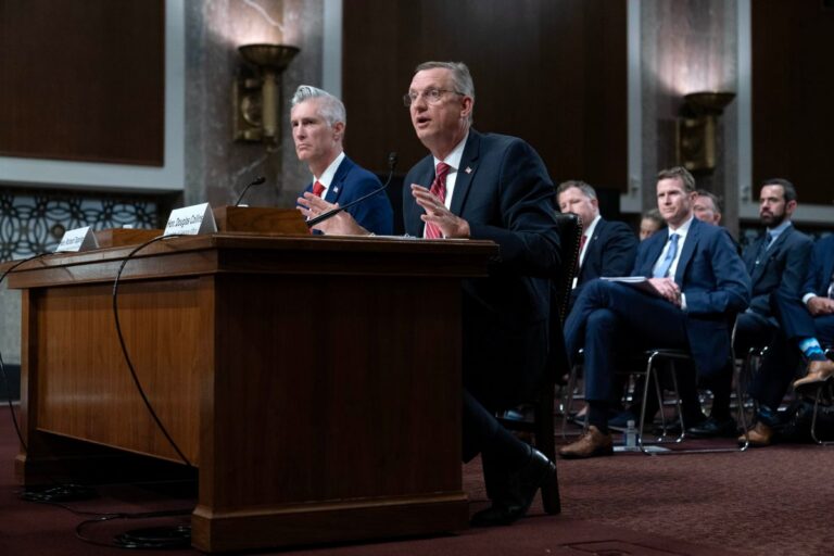 Veterans Affairs Secretary Doug Collins sitting at a desk during a Senate hearing on Capitol Hill.