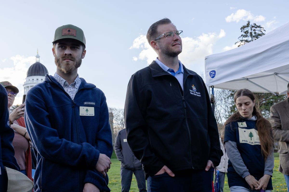 Martin Heald and Trey Stewart seen listening to a speaker during the event.