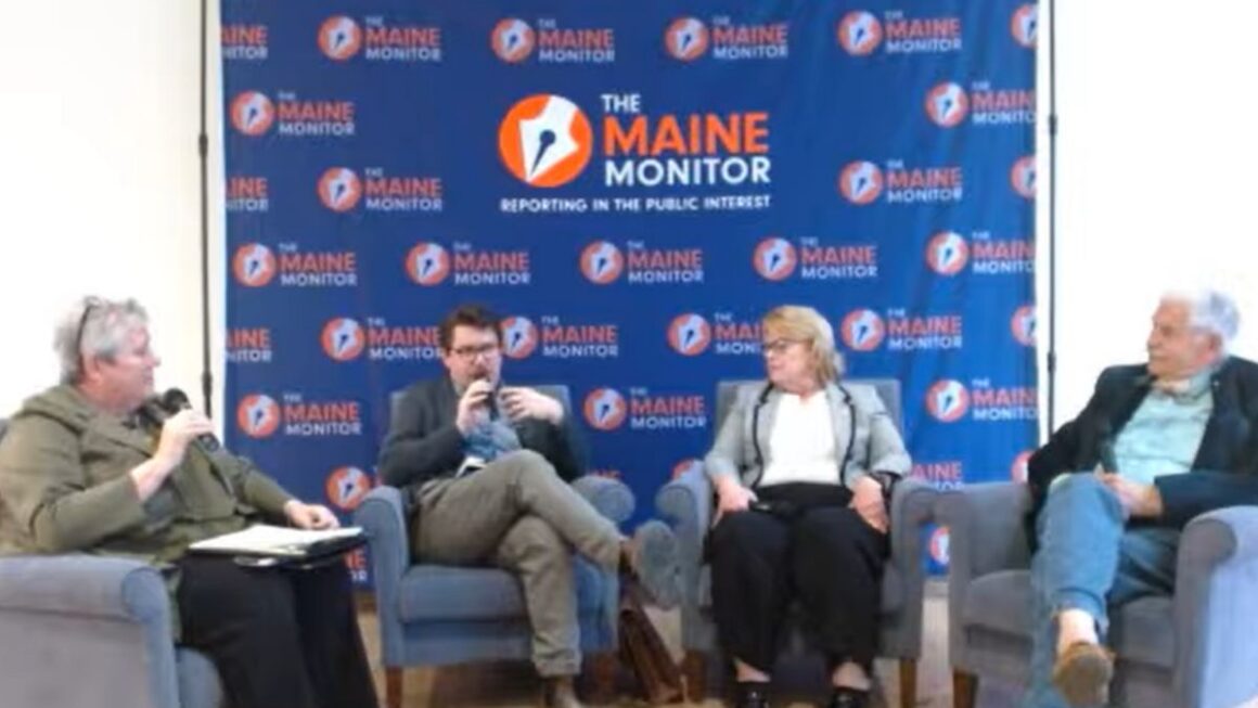 Panelists sit during the discussion.